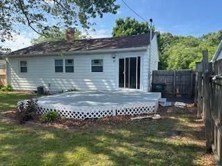 1507 7th St, Winthrop Harbor, IL 60096 - back of property featuring a fenced backyard, a wooden deck, and a chimney
