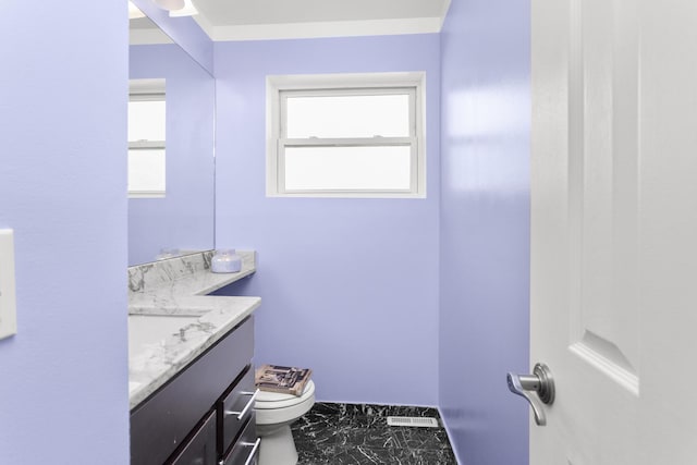 half bathroom with visible vents, toilet, marble finish floor, and vanity