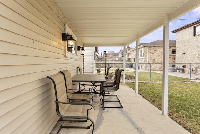 view of patio with outdoor dining area and fence