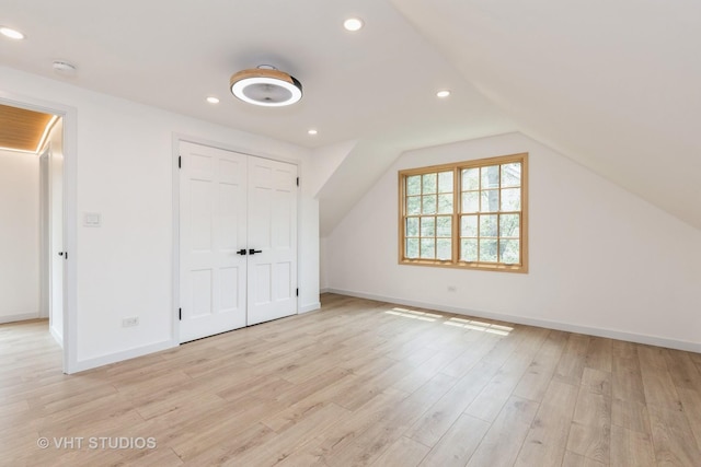 639 Harms Rd, Glenview, IL 60025 - unfurnished bedroom with light wood-type flooring, lofted ceiling, recessed lighting, and a closet