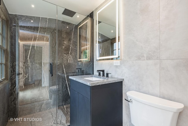 639 Harms Rd, Glenview, IL 60025 - full bathroom with toilet, tile walls, a marble finish shower, vanity, and marble tiled floors