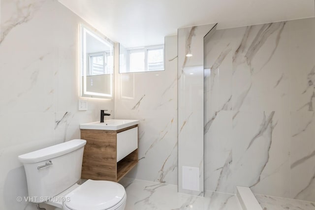 639 Harms Rd, Glenview, IL 60025 - bathroom featuring vanity, toilet, a marble finish shower, and tile walls