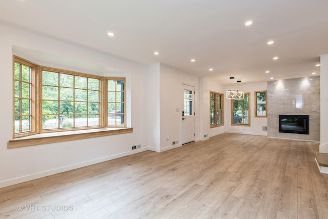 639 Harms Rd, Glenview, IL 60025 - unfurnished living room with baseboards, a large fireplace, light wood finished floors, and recessed lighting