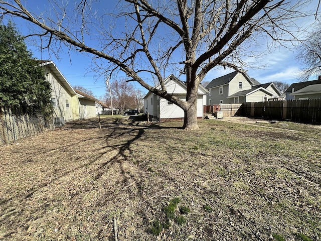 view of yard featuring fence and a residential view