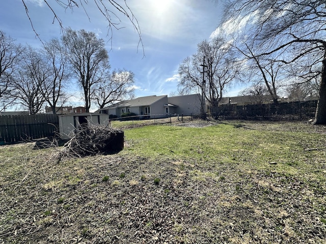 view of yard featuring an outbuilding and a fenced backyard
