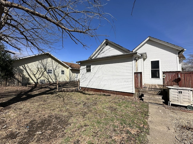 view of side of property featuring a wooden deck