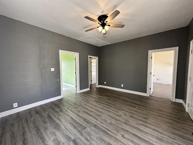 unfurnished room featuring wood finished floors, a ceiling fan, baseboards, and a textured ceiling