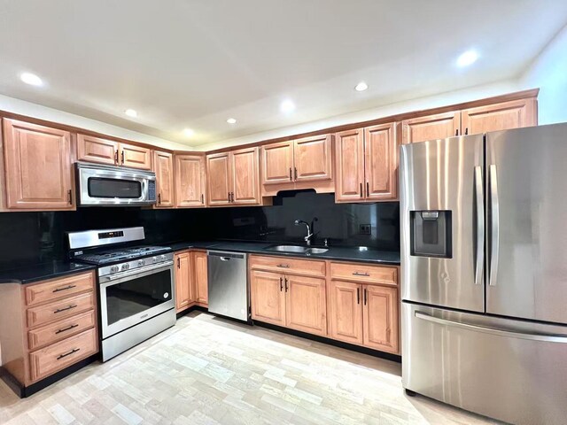 kitchen with a glass covered fireplace, a kitchen bar, light wood finished floors, baseboards, and visible vents