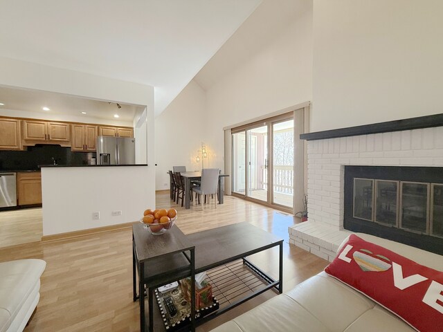 living room featuring recessed lighting, visible vents, and light wood-type flooring