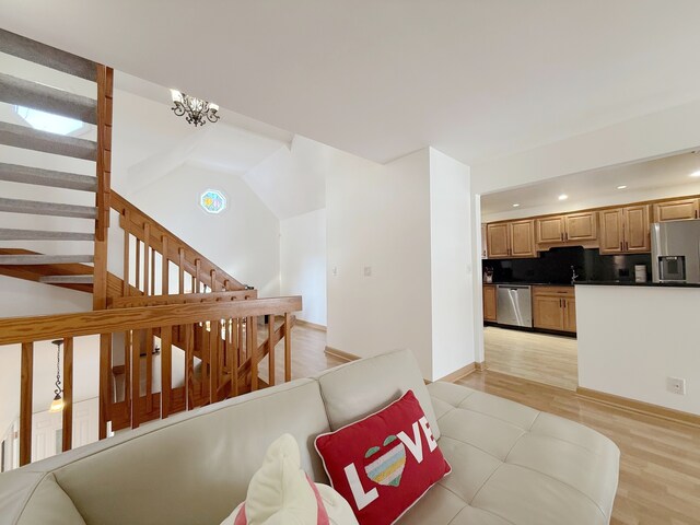 living room featuring recessed lighting, baseboards, lofted ceiling, and light wood-style floors