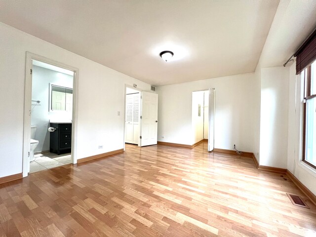 unfurnished bedroom with baseboards, visible vents, and light wood-style flooring
