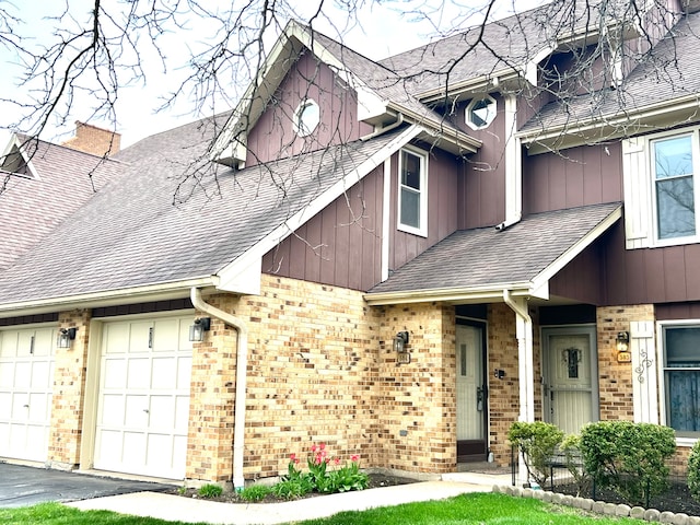 view of front of property with brick siding, board and batten siding, and roof with shingles
