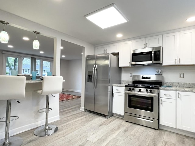 1299 Riverlane Dr, Bradley, IL 60915 - kitchen featuring light wood-type flooring, white cabinets, and stainless steel appliances