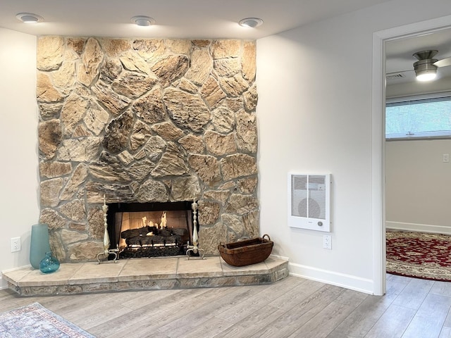1299 Riverlane Dr, Bradley, IL 60915 - details featuring visible vents, baseboards, wood finished floors, a stone fireplace, and heating unit