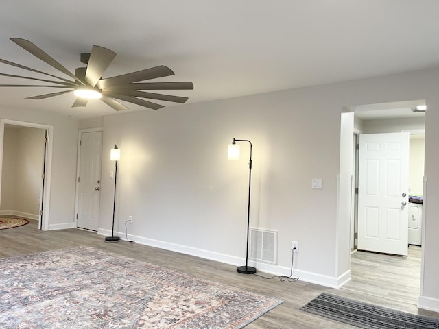 1299 Riverlane Dr, Bradley, IL 60915 - spare room with baseboards, washer / dryer, light wood finished floors, visible vents, and a ceiling fan