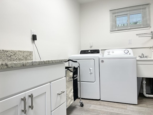 1299 Riverlane Dr, Bradley, IL 60915 - washroom featuring light wood finished floors, separate washer and dryer, cabinet space, and a sink