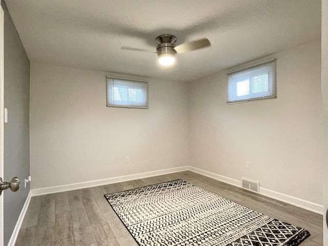 1299 Riverlane Dr, Bradley, IL 60915 - basement with baseboards, a textured ceiling, dark wood-style floors, and visible vents
