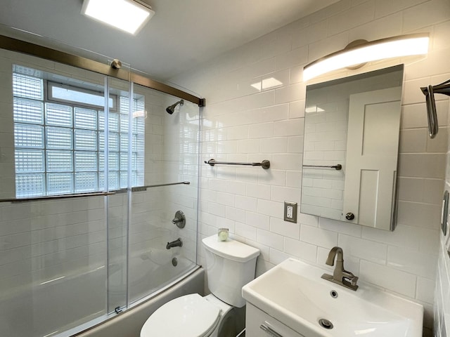 1299 Riverlane Dr, Bradley, IL 60915 - bathroom with plenty of natural light, shower / bath combination with glass door, tile walls, and decorative backsplash