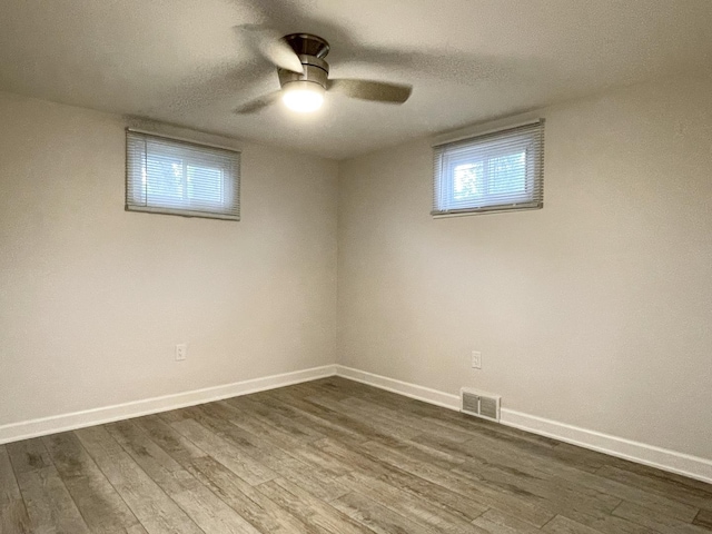 1299 Riverlane Dr, Bradley, IL 60915 - spare room with baseboards, dark wood-style flooring, visible vents, and a ceiling fan
