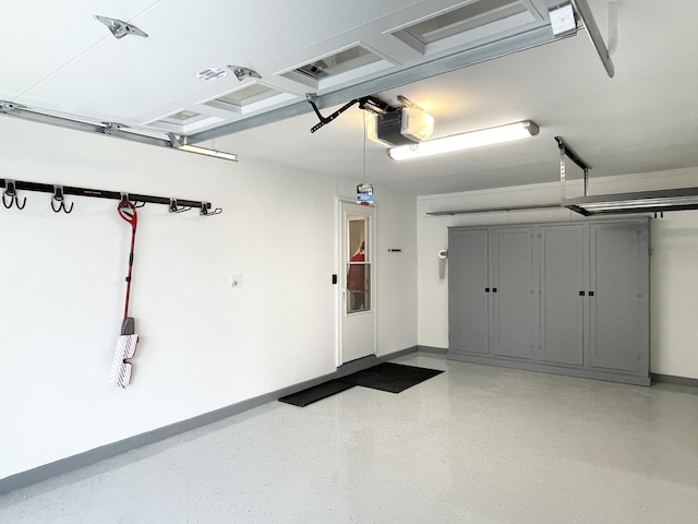 1299 Riverlane Dr, Bradley, IL 60915 - garage with baseboards and a garage door opener