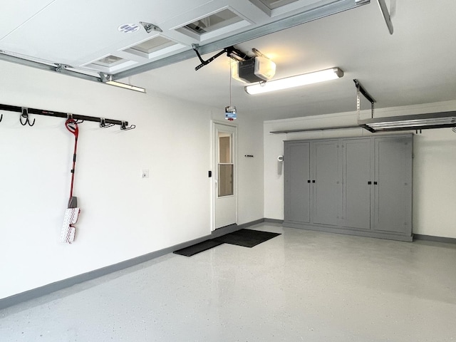 1299 Riverlane Dr, Bradley, IL 60915 - garage featuring a garage door opener and baseboards