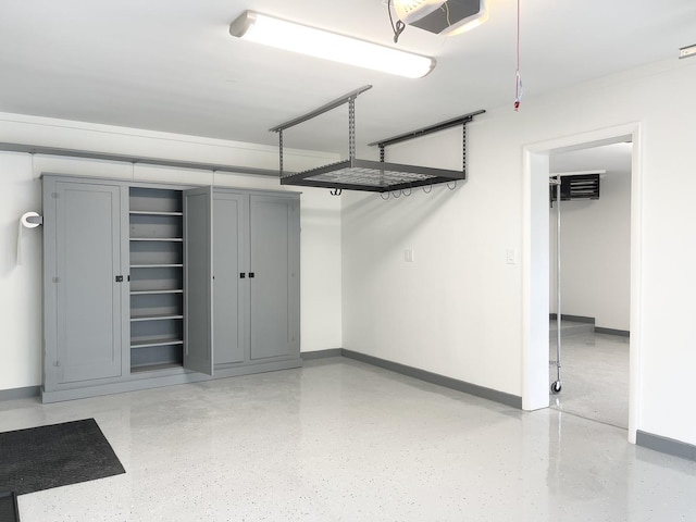 1299 Riverlane Dr, Bradley, IL 60915 - garage featuring baseboards and a garage door opener