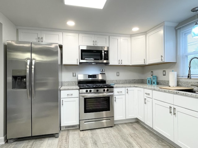 1299 Riverlane Dr, Bradley, IL 60915 - kitchen featuring a sink, light wood finished floors, stainless steel appliances, white cabinets, and recessed lighting
