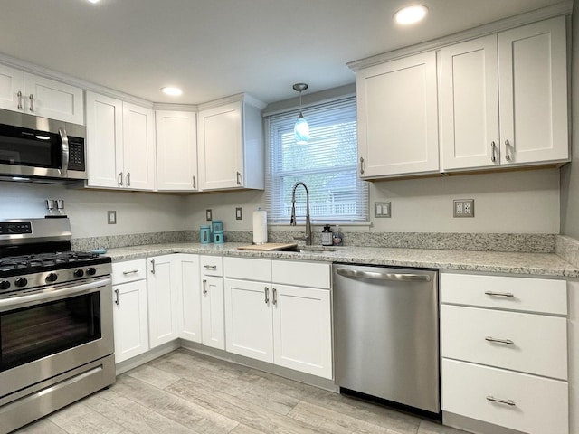 1299 Riverlane Dr, Bradley, IL 60915 - kitchen with light wood-style flooring, recessed lighting, appliances with stainless steel finishes, white cabinetry, and a sink