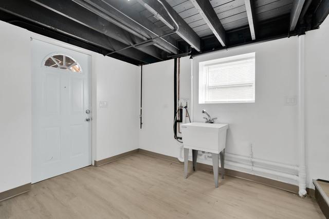 below grade area featuring baseboards and light wood finished floors