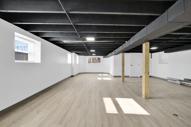 below grade area featuring baseboards and wood finished floors