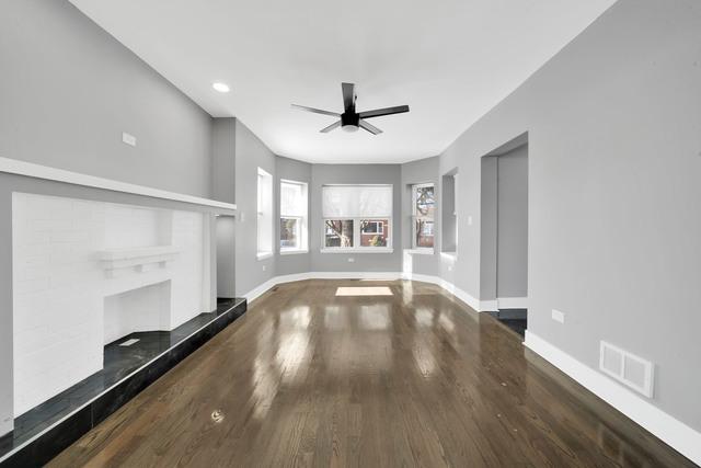 unfurnished living room with visible vents, baseboards, a ceiling fan, and wood finished floors