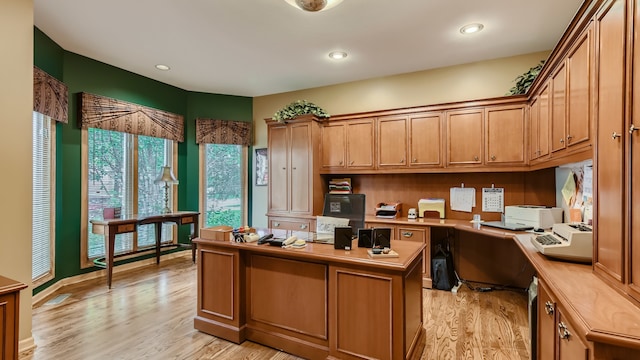home office featuring recessed lighting, light wood finished floors, and built in study area