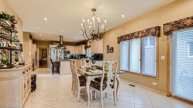 dining room featuring light tile patterned flooring, recessed lighting, plenty of natural light, and a chandelier