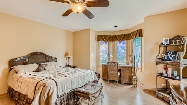 bedroom with baseboards, light wood-style floors, and ceiling fan