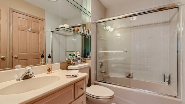 full bathroom with vanity, toilet, and bath / shower combo with glass door