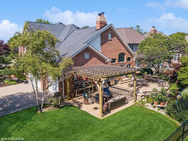back of property featuring a lawn, an outdoor hangout area, a chimney, a pergola, and a patio