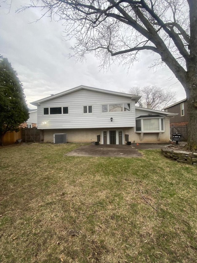 back of property with a lawn, fence, a patio area, and cooling unit