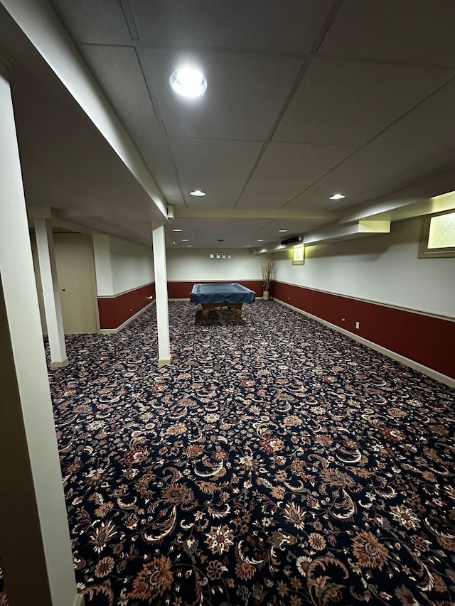 finished below grade area featuring billiards and a paneled ceiling