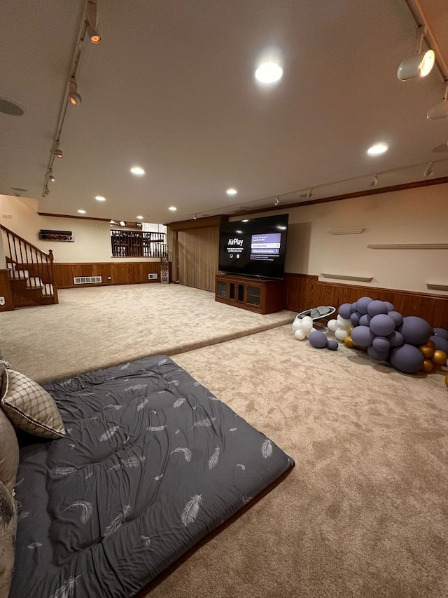 interior space with wooden walls, wainscoting, recessed lighting, and track lighting