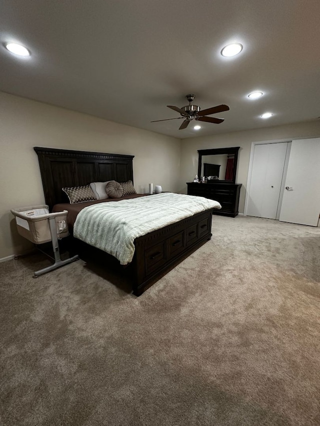 bedroom with ceiling fan, light carpet, and recessed lighting