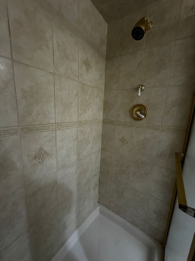 bathroom with a tile shower