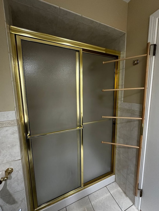 bathroom with tile patterned flooring and a stall shower
