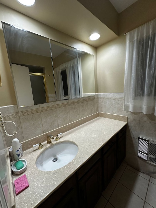 bathroom featuring tile patterned flooring, vanity, tile walls, an enclosed shower, and visible vents