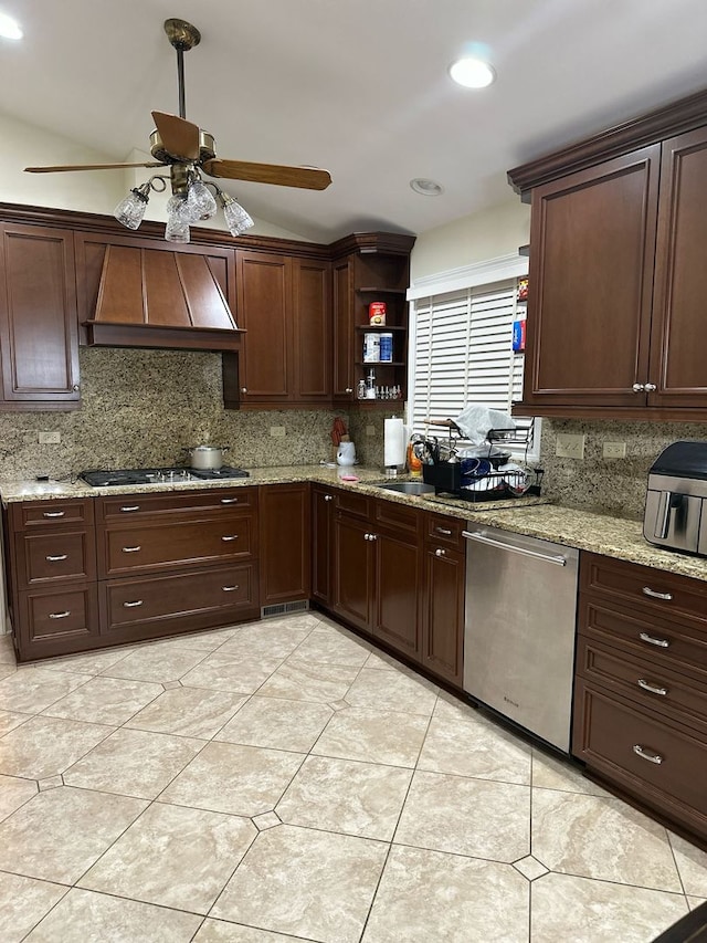 kitchen featuring decorative backsplash, lofted ceiling, ceiling fan, custom range hood, and stainless steel appliances