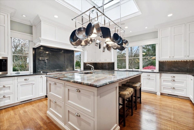 kitchen with backsplash and white cabinetry