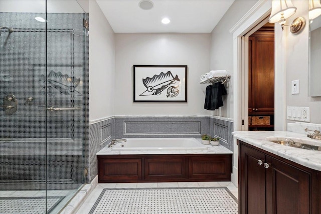 full bathroom featuring a bath, vanity, wainscoting, and a shower stall