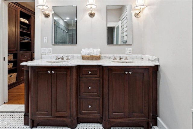 bathroom with walk in shower, double vanity, and a sink