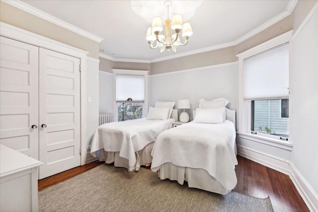 bedroom with an inviting chandelier, wood finished floors, baseboards, and ornamental molding