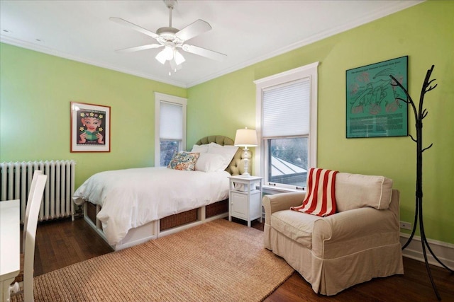bedroom featuring ornamental molding, radiator, a ceiling fan, and wood finished floors