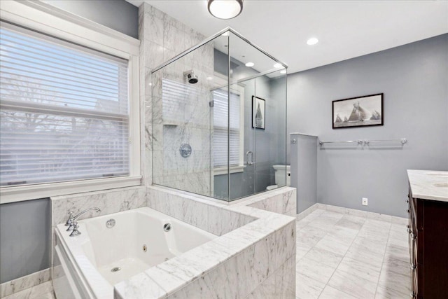 bathroom featuring vanity, a whirlpool tub, and a shower stall